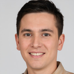 Joyful white young-adult male with short  brown hair and brown eyes