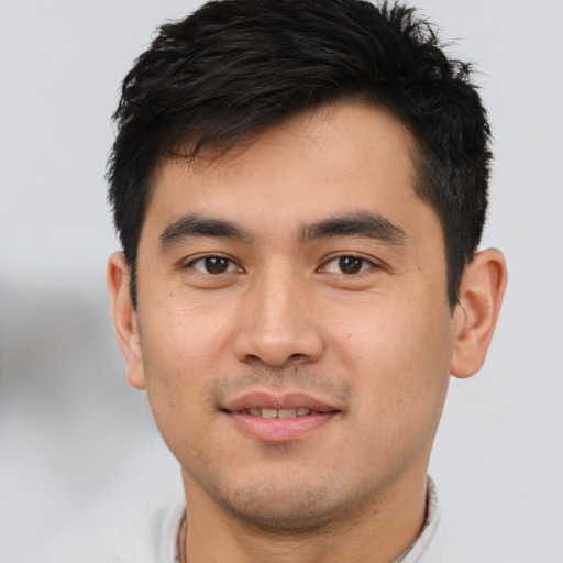 Joyful asian young-adult male with short  black hair and brown eyes
