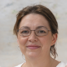 Joyful white adult female with medium  brown hair and brown eyes