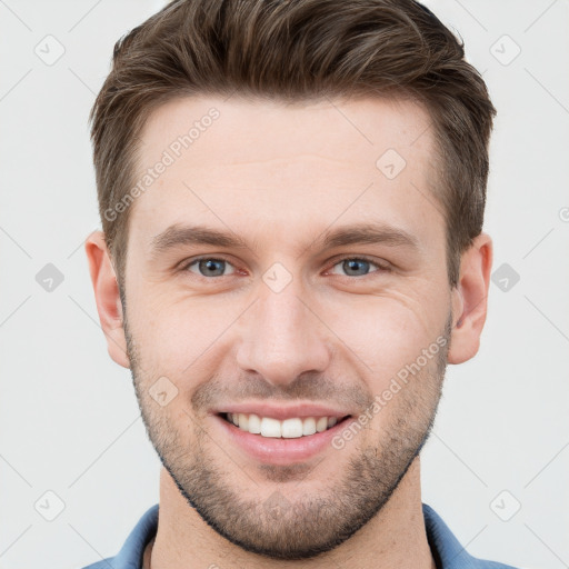 Joyful white young-adult male with short  brown hair and grey eyes