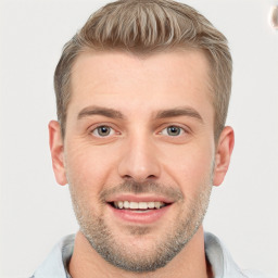 Joyful white young-adult male with short  brown hair and grey eyes