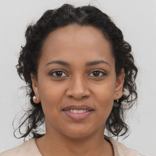 Joyful black young-adult female with medium  brown hair and brown eyes