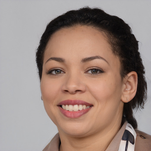 Joyful latino young-adult female with medium  brown hair and brown eyes