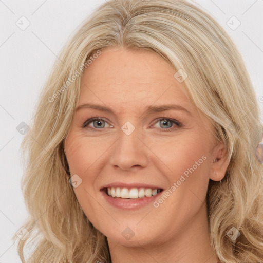 Joyful white adult female with long  brown hair and brown eyes