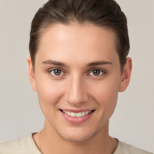 Joyful white young-adult female with short  brown hair and brown eyes