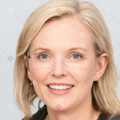 Joyful white adult female with medium  brown hair and blue eyes