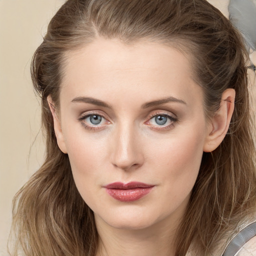 Joyful white young-adult female with long  brown hair and grey eyes