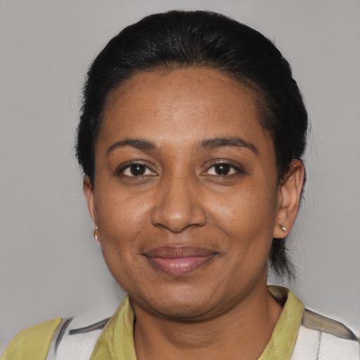 Joyful black adult female with short  black hair and brown eyes