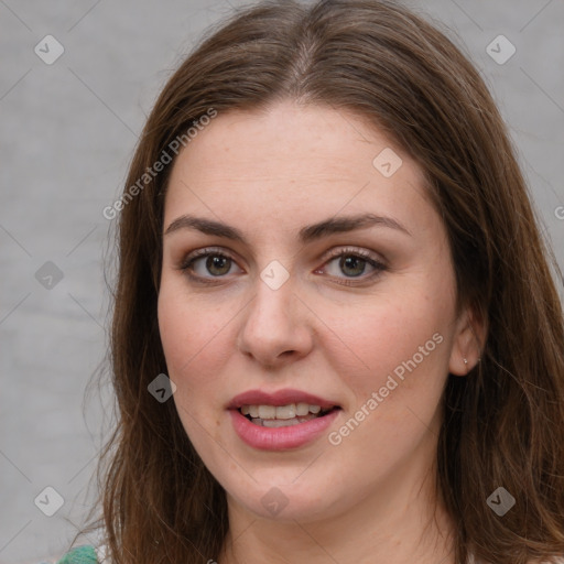 Joyful white young-adult female with long  brown hair and green eyes