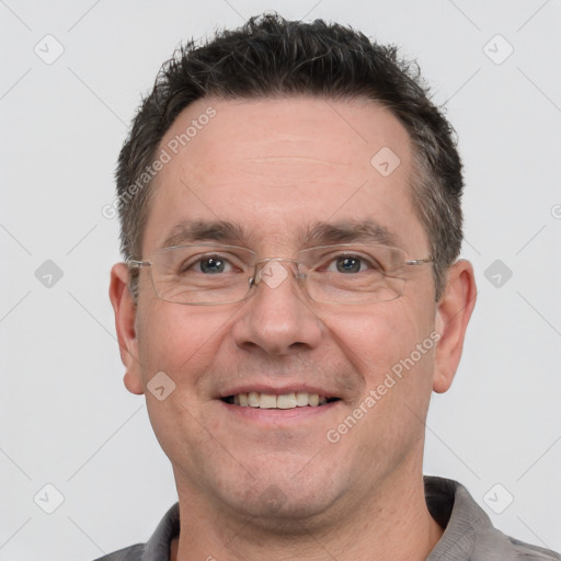 Joyful white adult male with short  brown hair and grey eyes