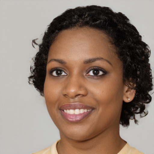 Joyful black young-adult female with medium  black hair and brown eyes