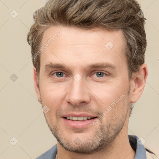 Joyful white adult male with short  brown hair and grey eyes