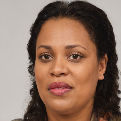 Joyful black adult female with medium  brown hair and brown eyes