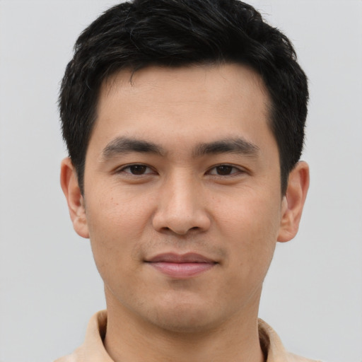 Joyful white young-adult male with short  black hair and brown eyes