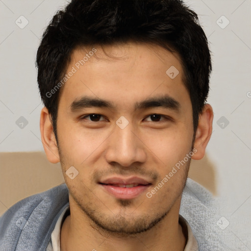 Joyful asian young-adult male with short  black hair and brown eyes