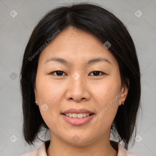 Joyful asian young-adult female with medium  brown hair and brown eyes