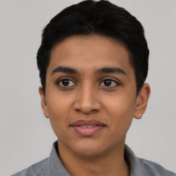 Joyful latino young-adult male with short  black hair and brown eyes