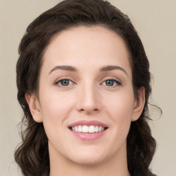 Joyful white young-adult female with long  brown hair and green eyes