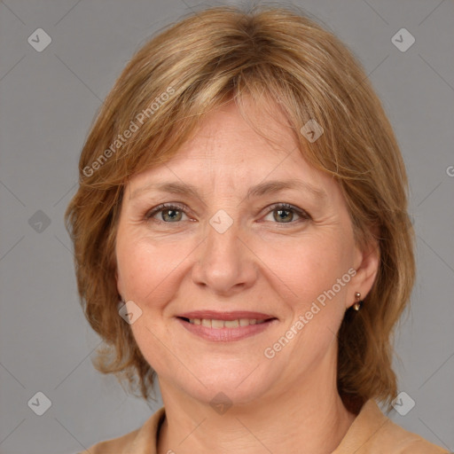 Joyful white adult female with medium  brown hair and blue eyes