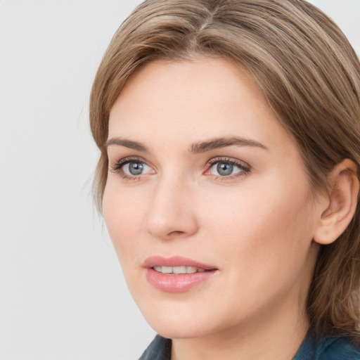 Joyful white young-adult female with medium  brown hair and blue eyes