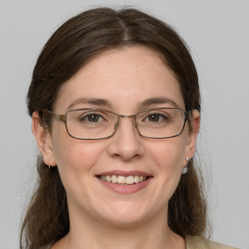 Joyful white adult female with medium  brown hair and blue eyes