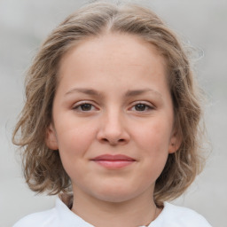 Joyful white child female with medium  brown hair and grey eyes