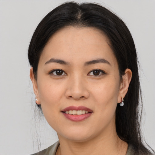 Joyful asian young-adult female with long  black hair and brown eyes