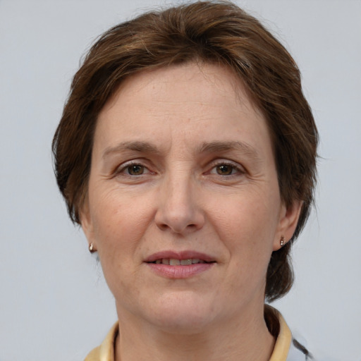 Joyful white adult female with short  brown hair and grey eyes