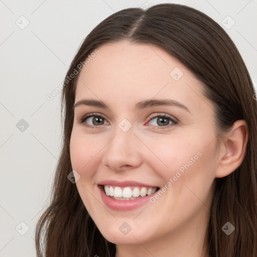 Joyful white young-adult female with long  brown hair and grey eyes