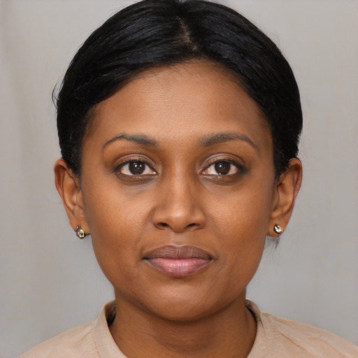 Joyful black young-adult female with short  brown hair and brown eyes
