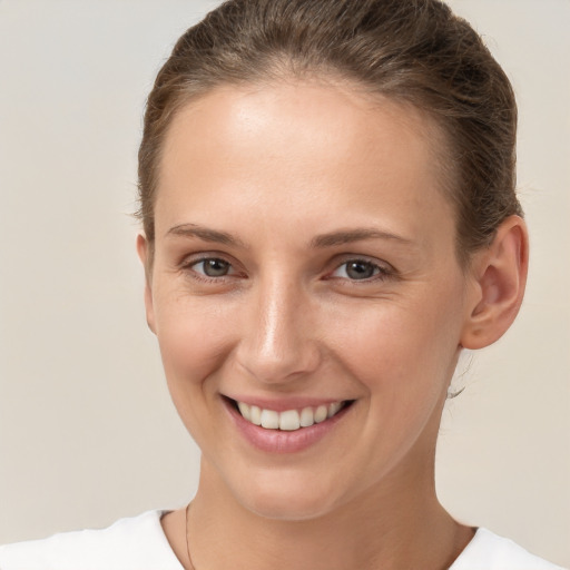 Joyful white young-adult female with short  brown hair and brown eyes