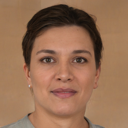 Joyful white young-adult female with short  brown hair and brown eyes