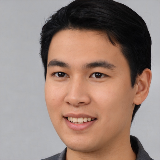 Joyful asian young-adult male with medium  black hair and brown eyes