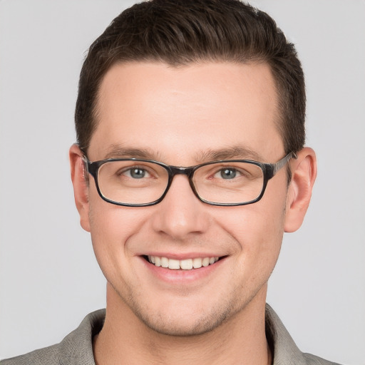 Joyful white young-adult male with short  brown hair and grey eyes