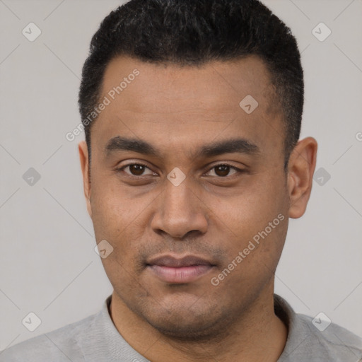 Joyful latino young-adult male with short  black hair and brown eyes