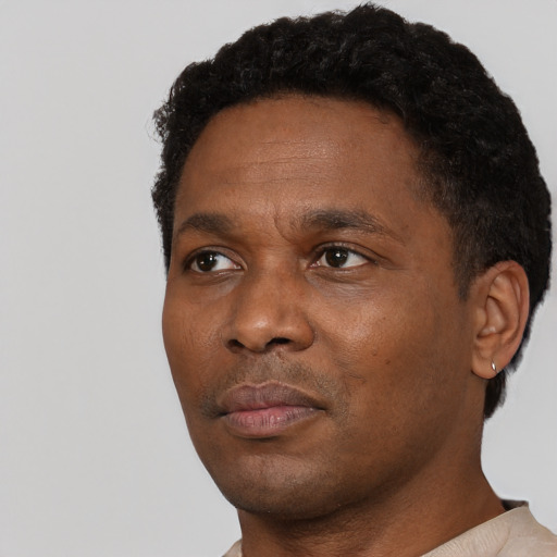 Neutral black adult male with short  black hair and brown eyes