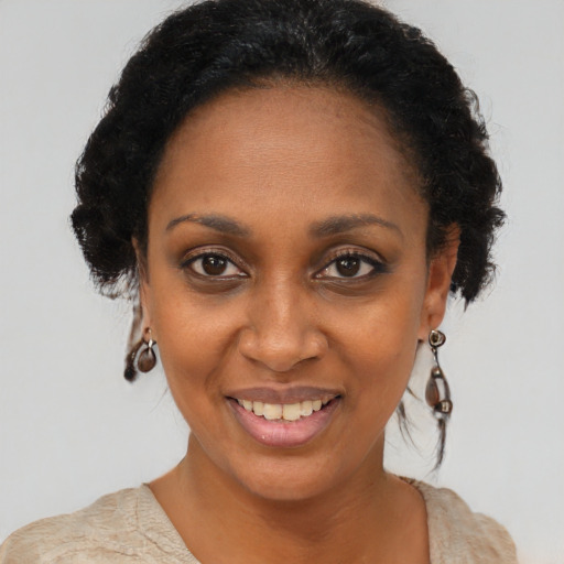 Joyful black young-adult female with short  brown hair and brown eyes