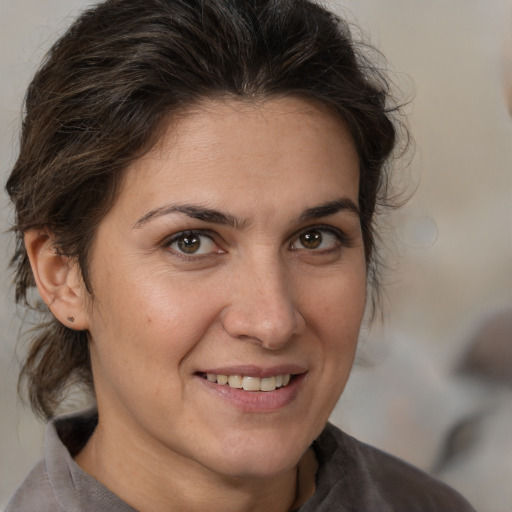 Joyful white adult female with medium  brown hair and brown eyes