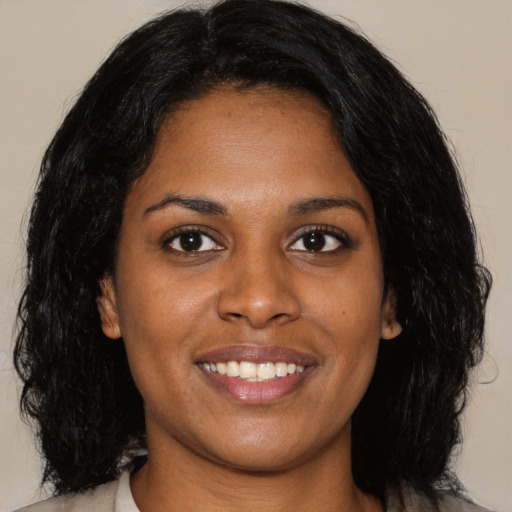 Joyful latino young-adult female with long  black hair and brown eyes