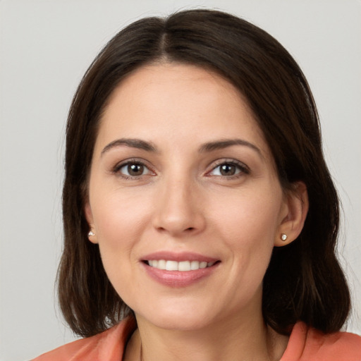 Joyful white young-adult female with medium  brown hair and brown eyes