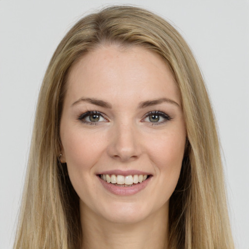 Joyful white young-adult female with long  brown hair and green eyes