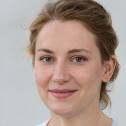 Joyful white adult female with medium  brown hair and brown eyes