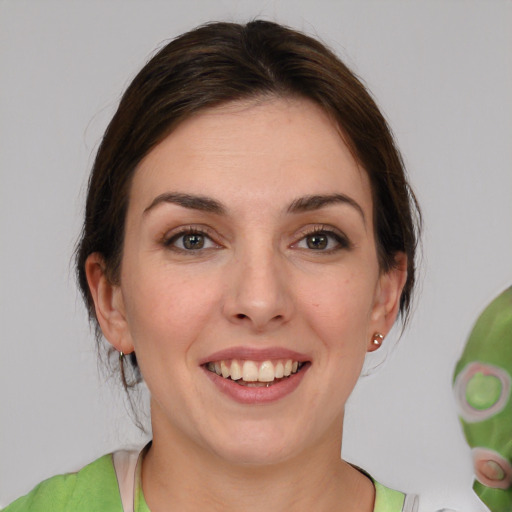 Joyful white young-adult female with medium  brown hair and brown eyes