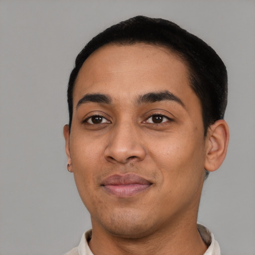 Joyful latino young-adult male with short  brown hair and brown eyes