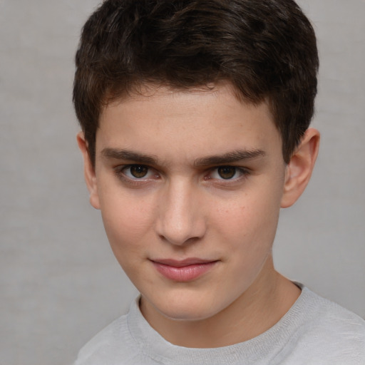 Joyful white child male with short  brown hair and brown eyes