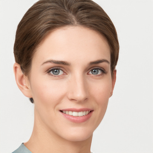 Joyful white young-adult female with short  brown hair and grey eyes