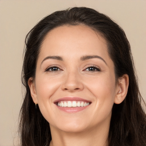 Joyful white young-adult female with long  brown hair and brown eyes