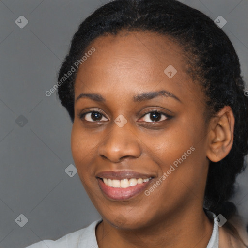 Joyful black young-adult female with short  black hair and brown eyes