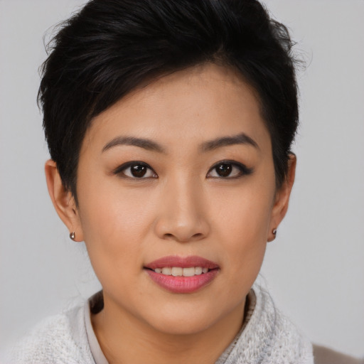 Joyful asian young-adult female with short  brown hair and brown eyes