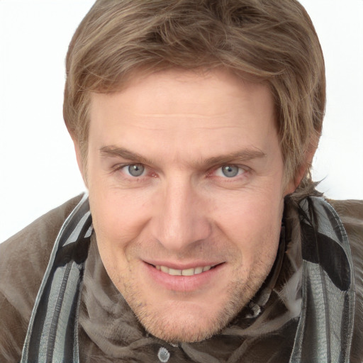 Joyful white adult male with short  brown hair and grey eyes